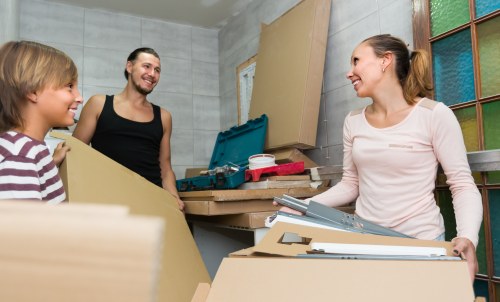 Removal team using safe lifting practices during a house move