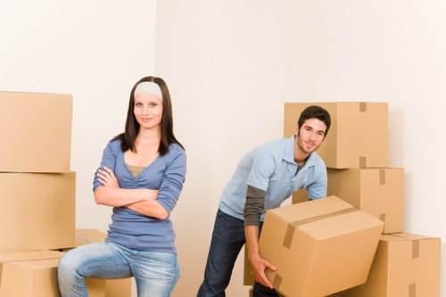 Careful unloading of boxes and furniture at a new Highwycombe home