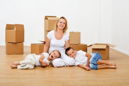 Local moving team unloading furniture at a Highwycombe property