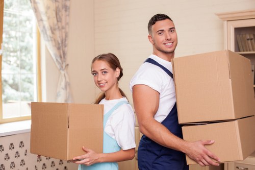 Professional movers handling furniture and boxes carefully